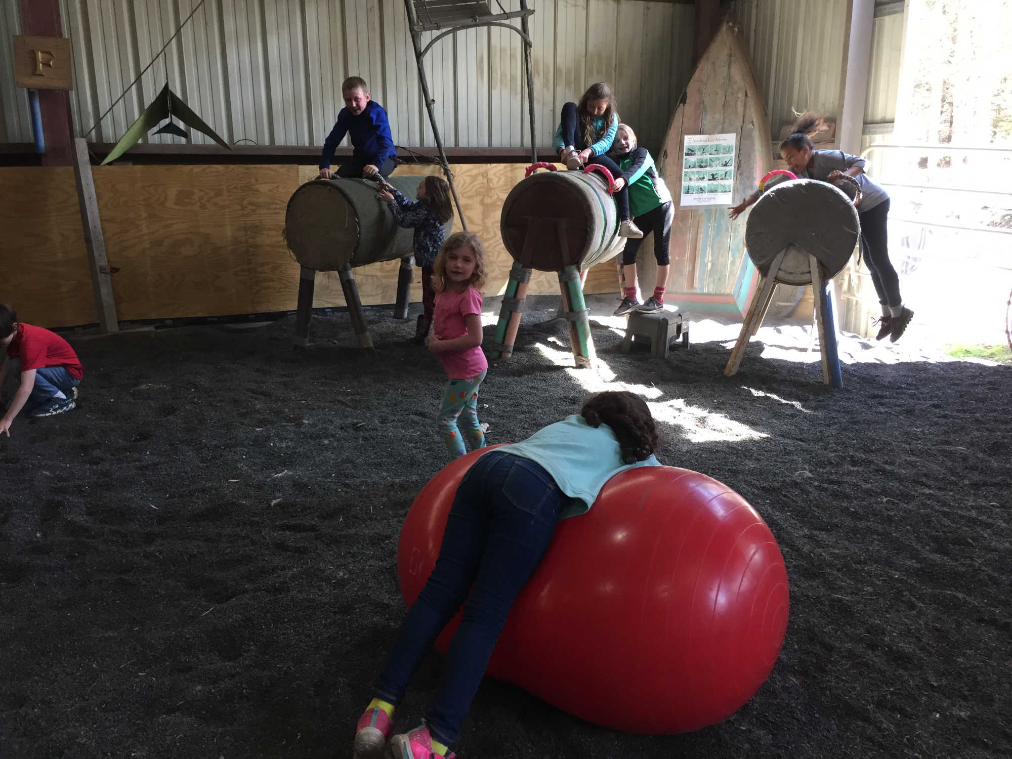 Children practicing mounting on barrels.